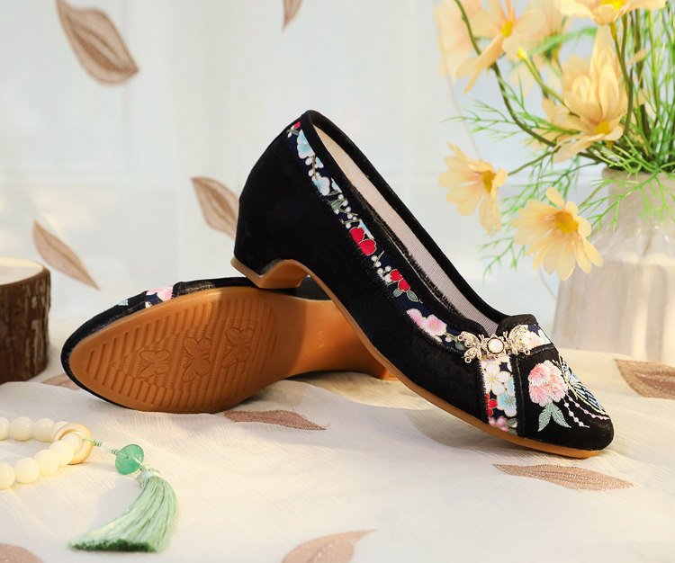 Back embroidery detail on black flats