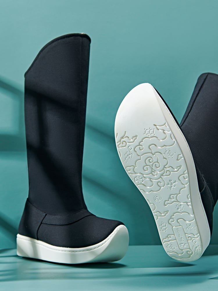 Black canvas tall Hanfu boots featuring a white outsole with embossed cloud and auspicious Chinese motifs, shown from the bottom and side angle.