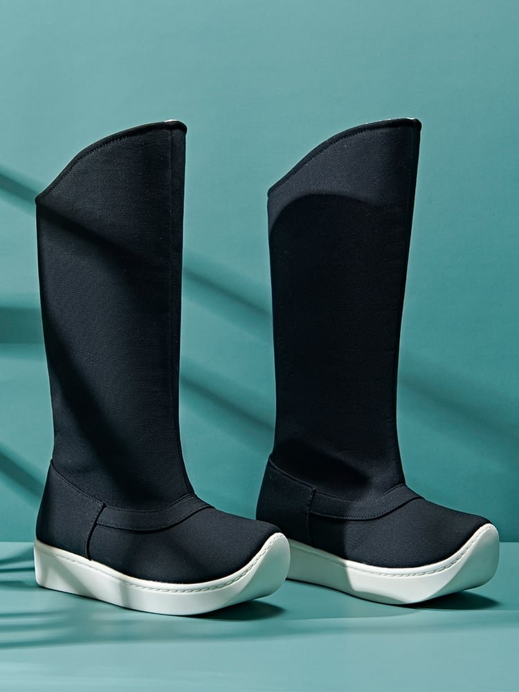 Rear-side angle of black canvas Hanfu boots showing the tall shaft shape and supportive white outsole for cultural wear and photography styling.