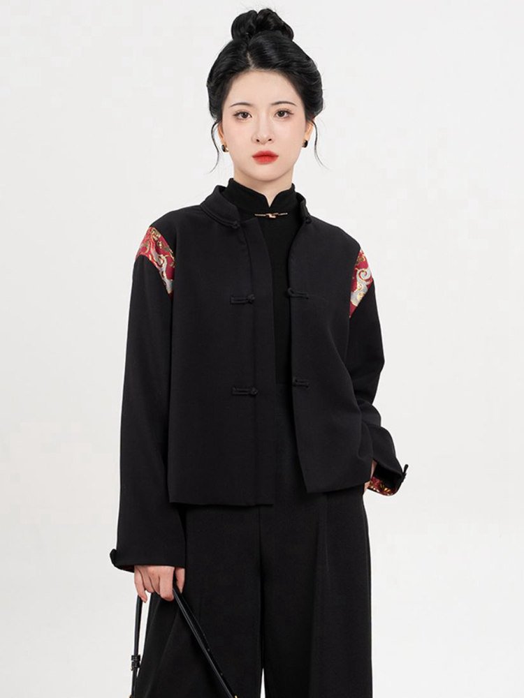Front view of black hoodie with red brocade shoulder accents