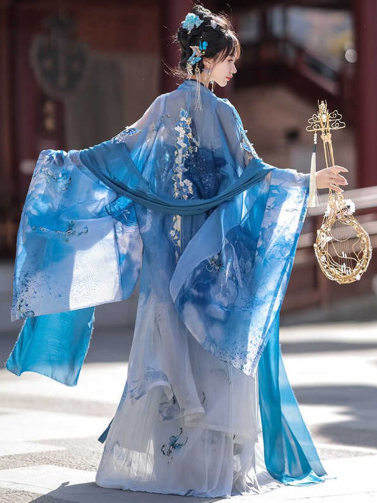 Back view of the butterfly embroidered blue Hanfu with flowing chiffon shawl.