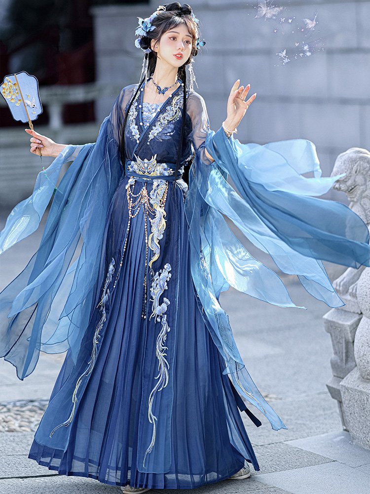 Model wearing the blue dragon Hanfu dress, front view highlighting embroidery and wide sleeves.