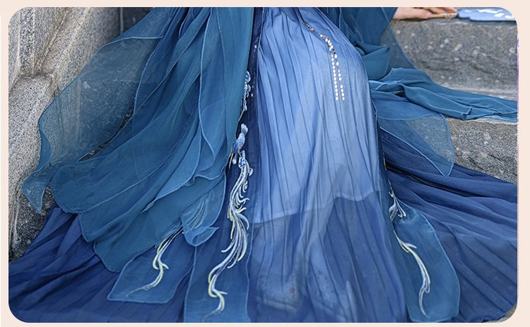 Close-up of the pleated skirt with embroidery details on the blue dragon Hanfu dress.