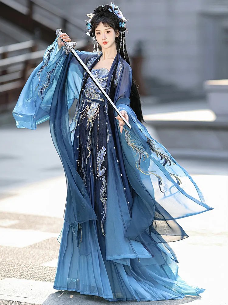 Model walking gracefully in blue dragon Hanfu dress with flowing sleeves.