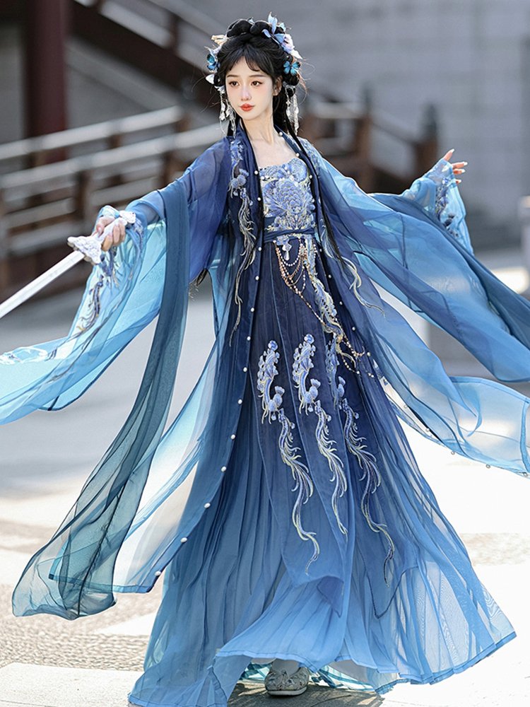 Model spreading wide sleeves of blue dragon Hanfu dress in motion.