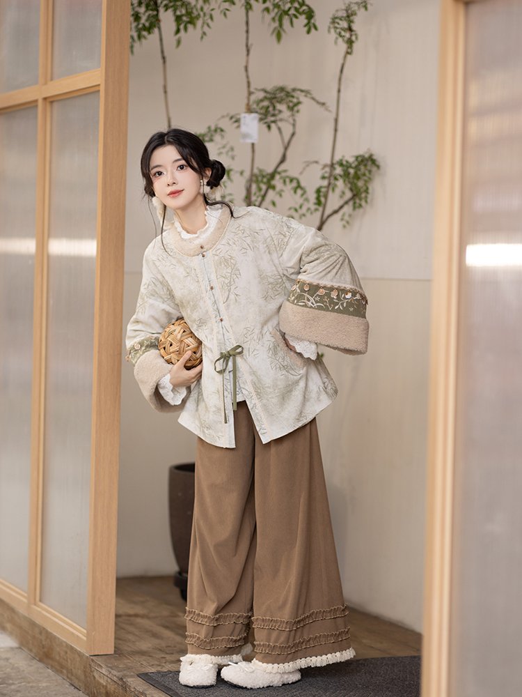 Indoor photo of woman sitting in Mist Bamboo Hanfu outfit.