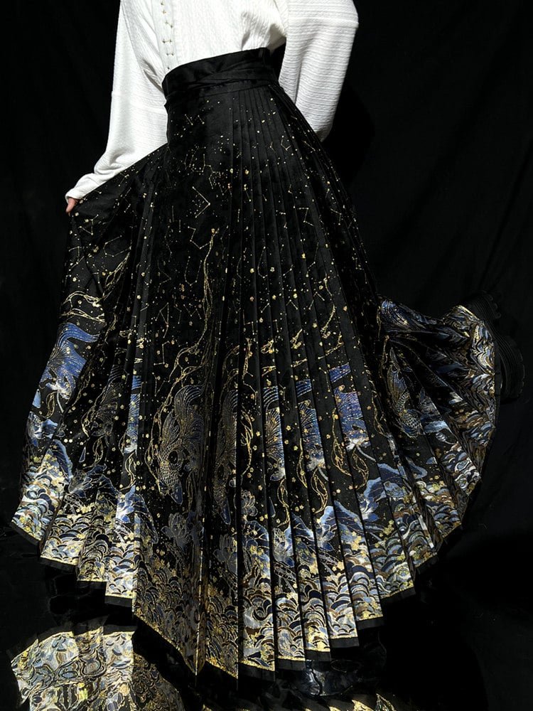 Fully expanded black skirt showing gold galaxy pleats and dragon motifs