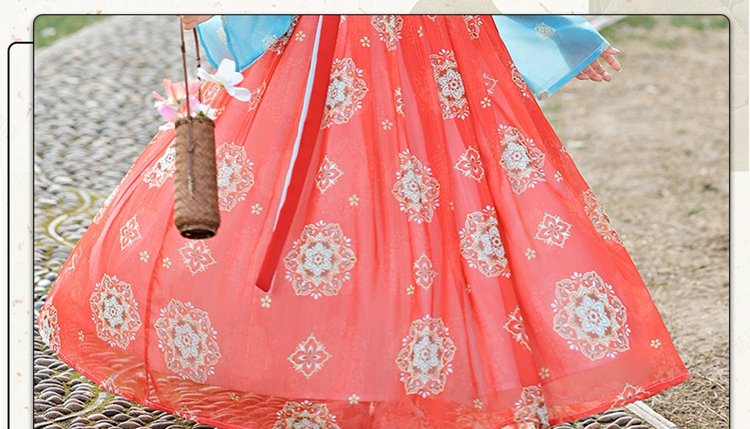 Detailed view of red embroidered skirt patterns and fabric texture