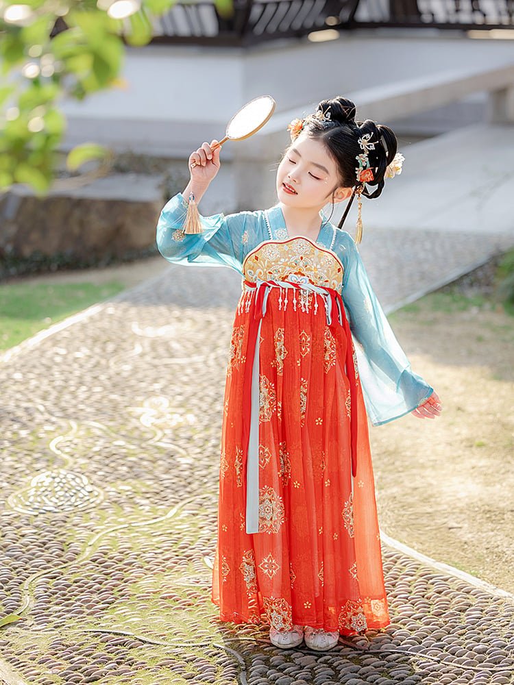 Girl posing with a traditional Chinese fan wearing a red and blue Dunhuang dress