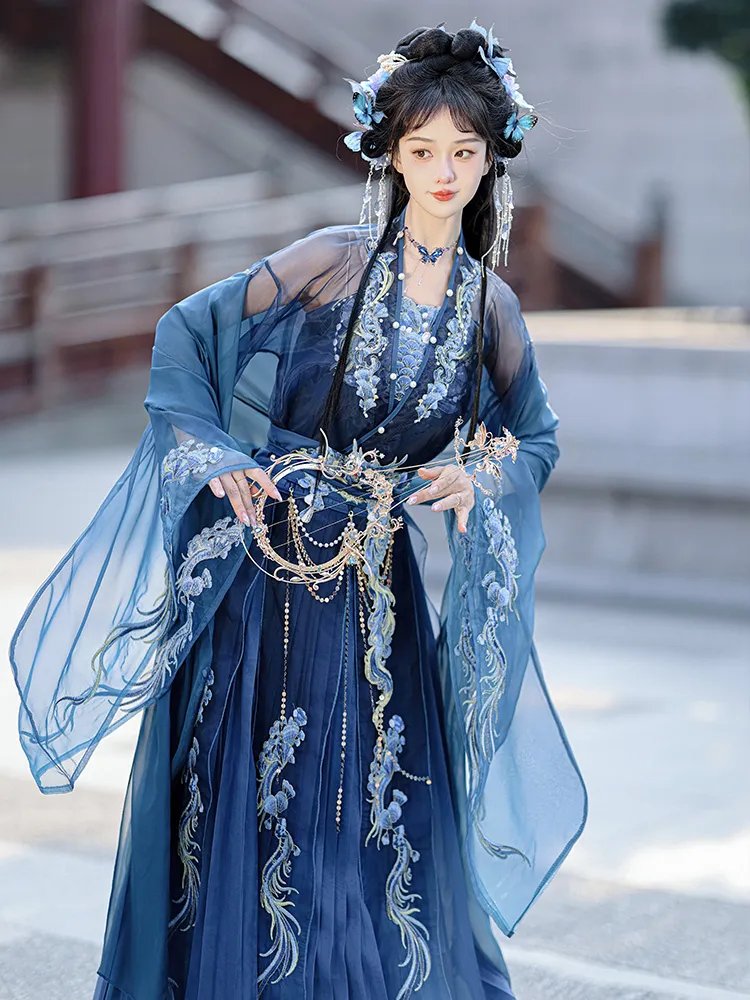Model posing in front view wearing embroidered blue Hanfu with long sleeves.