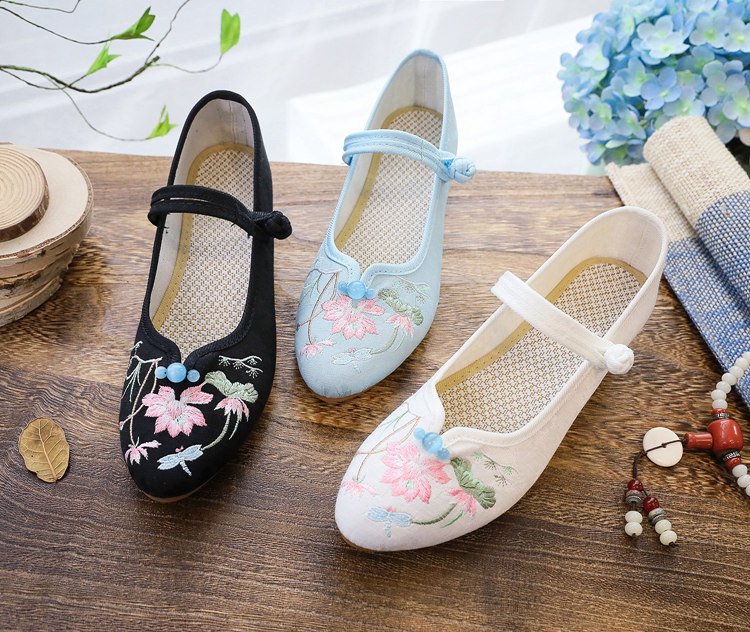 Flatlay of embroidered Mary Jane pumps