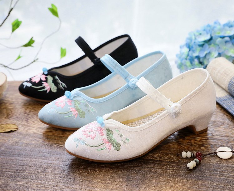 Embroidered Mary Jane shoes in blue, white, and black