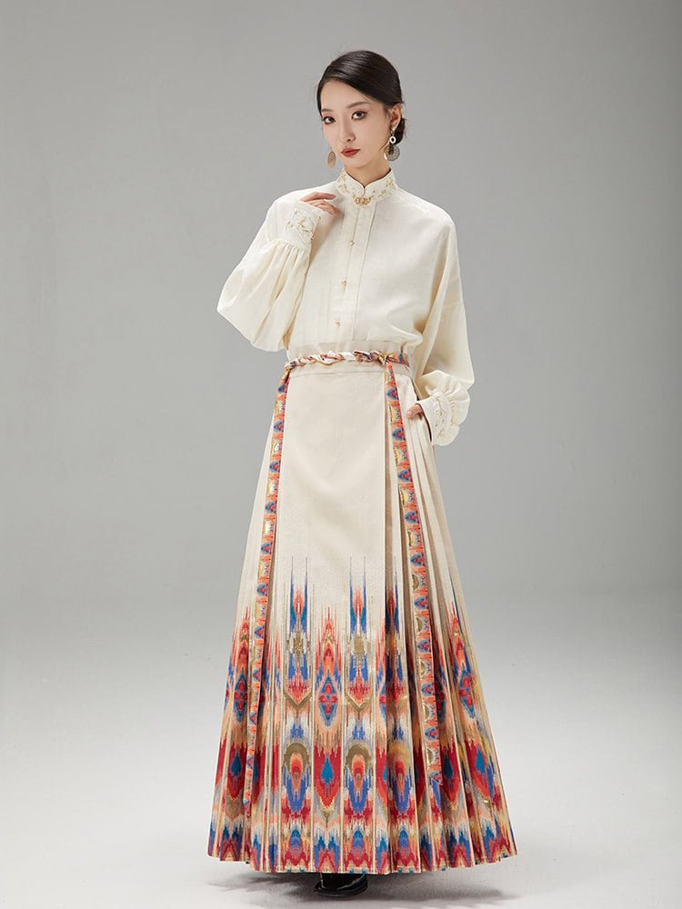 Side-angle view of the model wearing an ikat Hanfu Mamian skirt with bold geometric patterns and a cream blouse.
