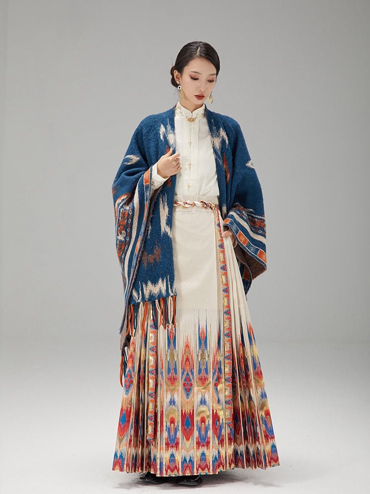 Model wearing the ikat Mamian skirt styled with a blue ethnic jacquard shawl.