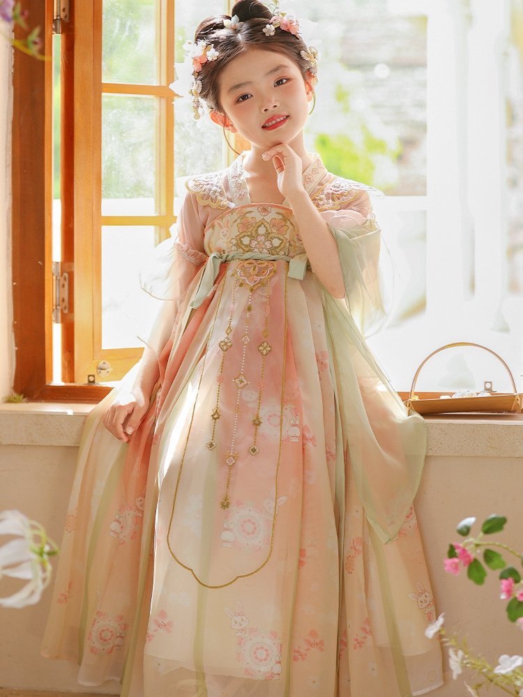Full-length view of a girl in an elegant pink Hanfu dress with floral patterns