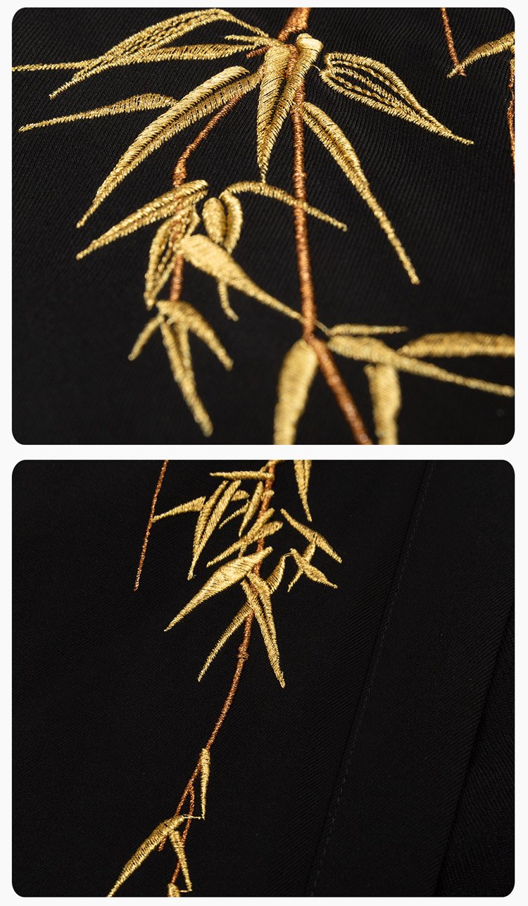 Close-up of gold bamboo embroidery on black fabric.