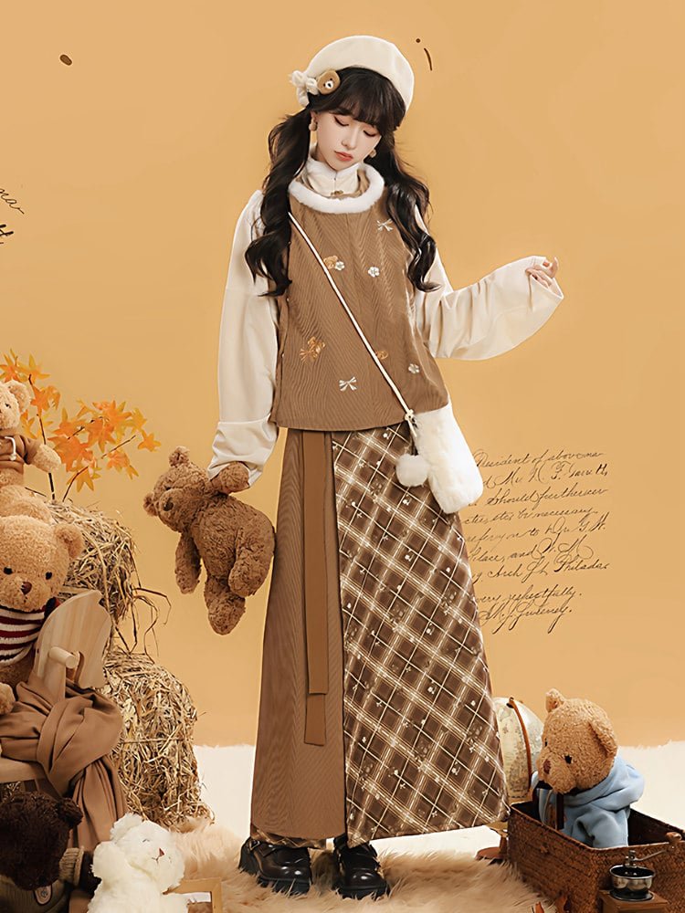Model wearing the brown hanfu-inspired winter outfit with warm layered top and plaid skirt