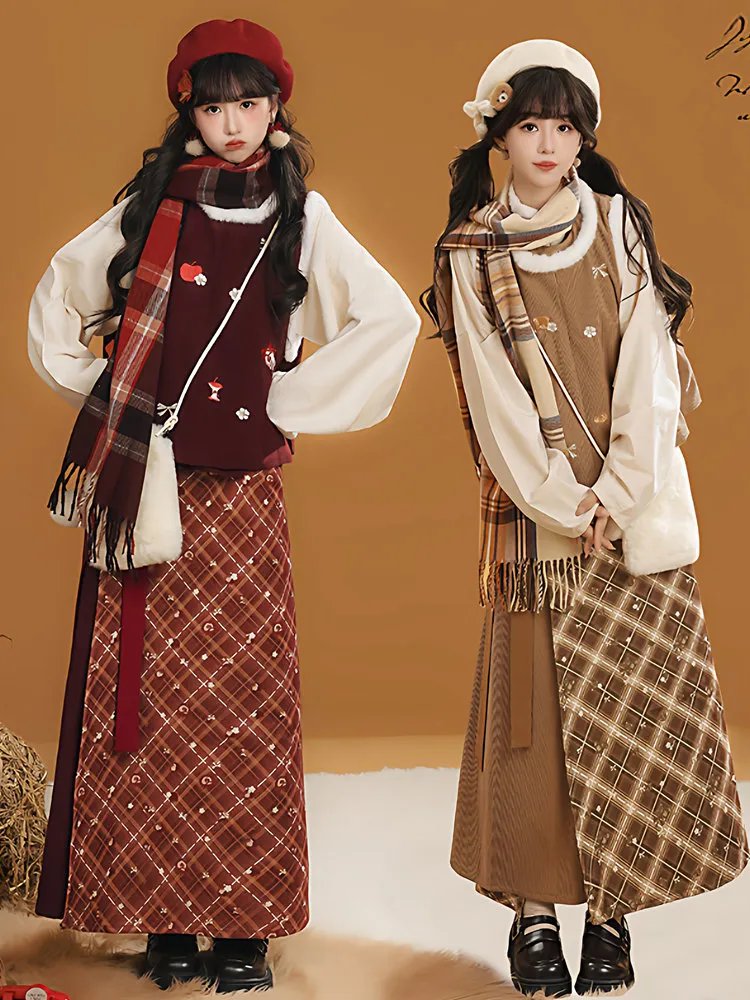 Two models wearing hanfu-inspired winter outfits in red and brown with warm tops and plaid skirts
