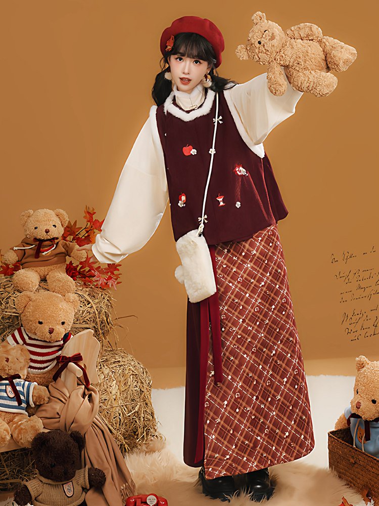 Model wearing the red hanfu-inspired winter outfit with plaid skirt and warm outerwear
