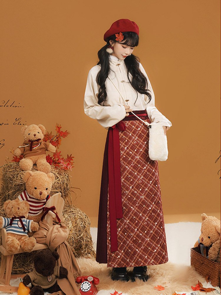 Model wearing red winter outfit among teddy bear props
