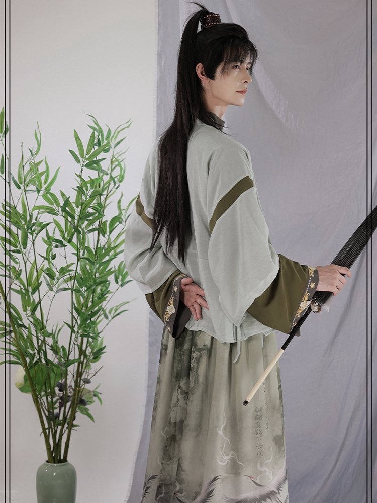 Elegant green chiffon Hanfu for men, styled with crane ink print and wide sleeves.