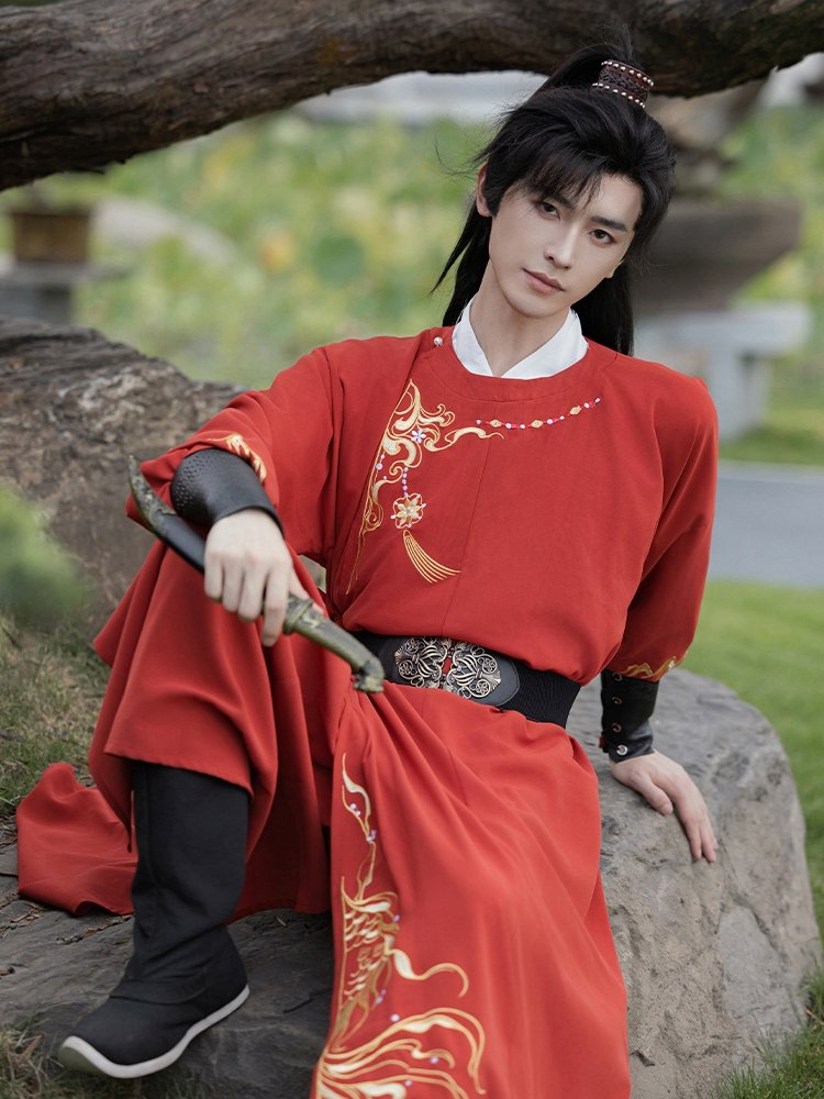 Gold embroidery detail on red Tang-style Hanfu robe, bamboo and cloud motifs.