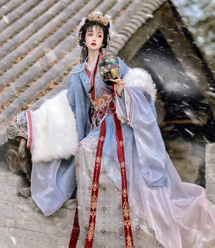 Model in blue-pink hanfu standing by textured wall