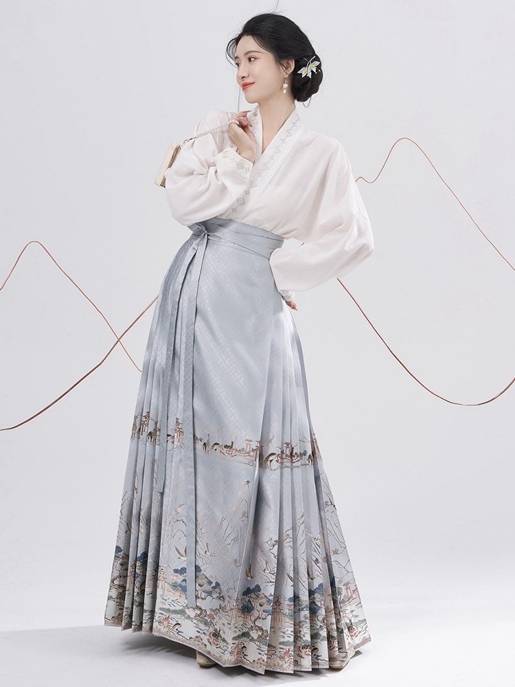 Model wearing blue landscape Ma Mian skirt with long-sleeve Hanfu top