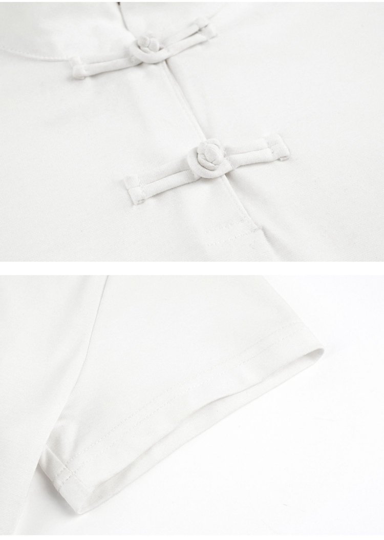 Close-up of button and sleeve construction on white Hanfu top