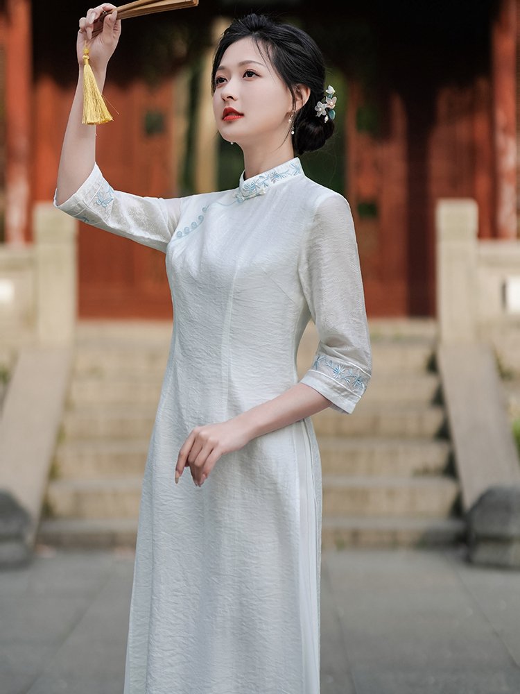 Side pose of woman wearing embroidered Mandarin Collar Hanfu Dress