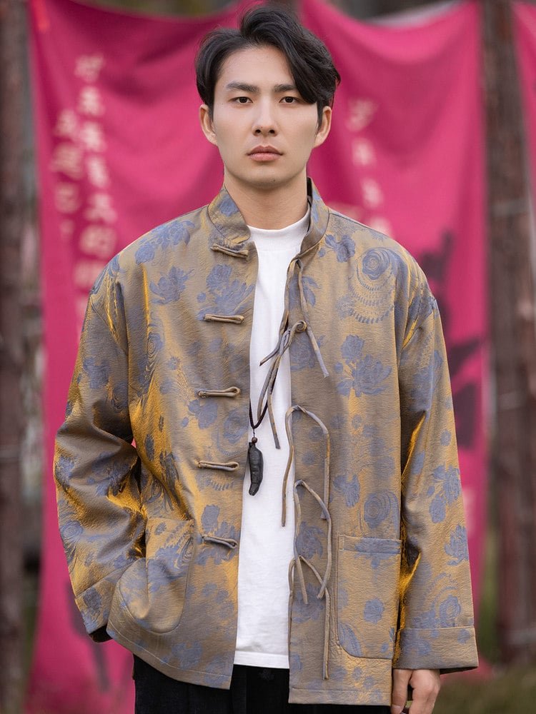 Model wearing a blue Chinese brocade jacket with mandarin collar and frog buttons, jacquard patterned fabric.