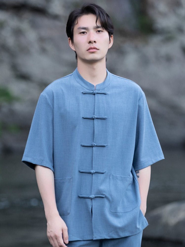 Close-up of the short sleeve mandarin collar shirt with frog buttons from a men’s Chinese summer outfit.