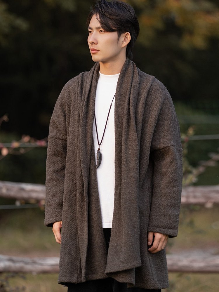 Side view of a man wearing a coffee-colored Hanfu-inspired Chinese winter robe coat with a relaxed open-front design.