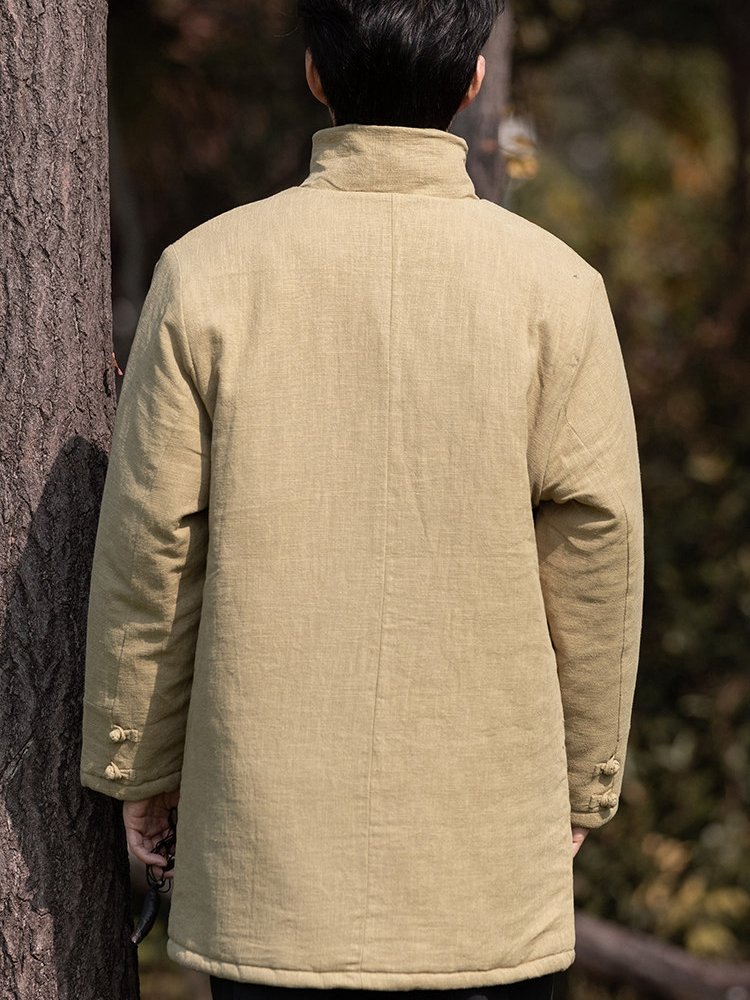 Back view of a yellow Chinese winter Tang jacket showing the padded construction and straight hem.