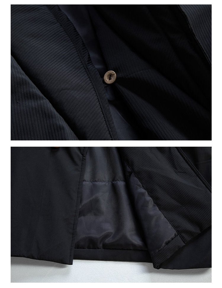 Close-up of the lining, stitching, and fabric texture of a black padded Chinese wrap winter jacket.