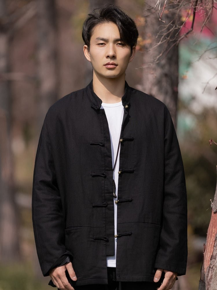 Front view of a black Chinese Tang jacket worn open to reveal inner layers, showcasing frog buttons and mandarin collar.