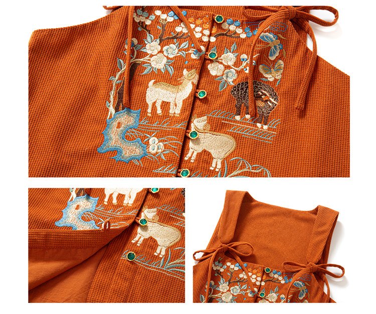 Front embroidery detail of the orange vest with floral and sheep pattern