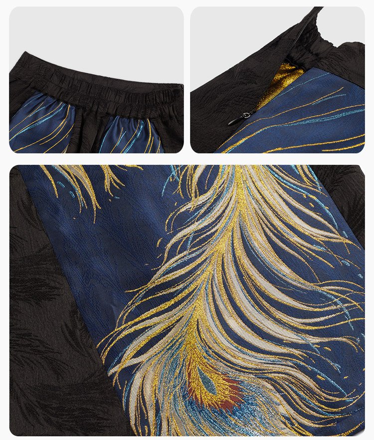Close-up of golden peacock embroidery on navy brocade fabric