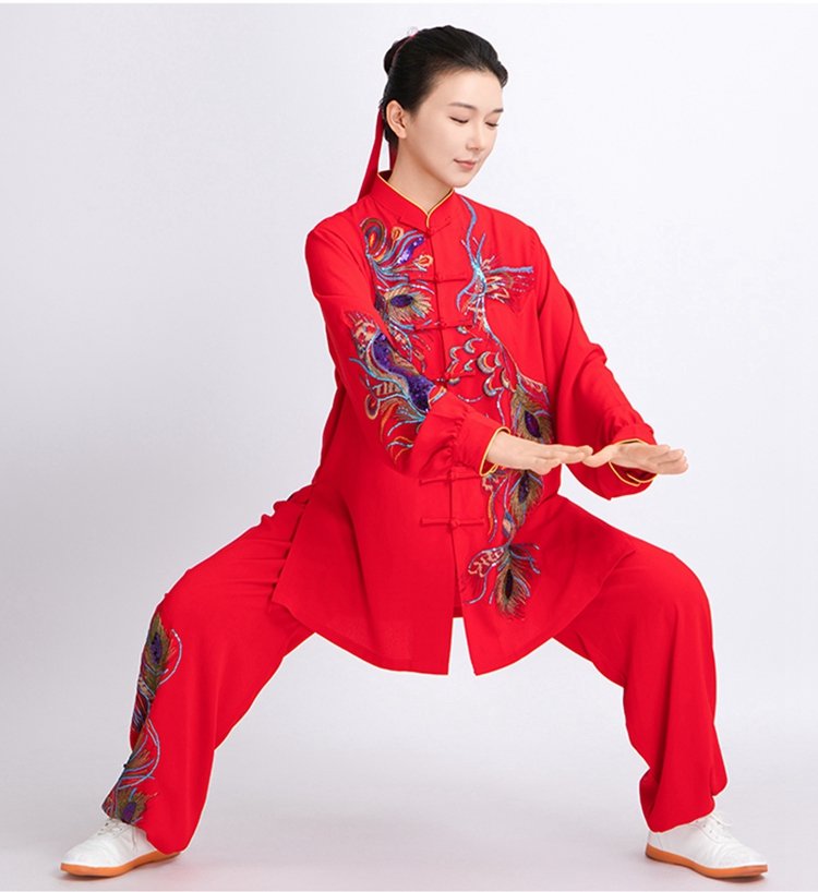 Woman wearing red phoenix embroidered Tai Chi uniform in martial arts stance