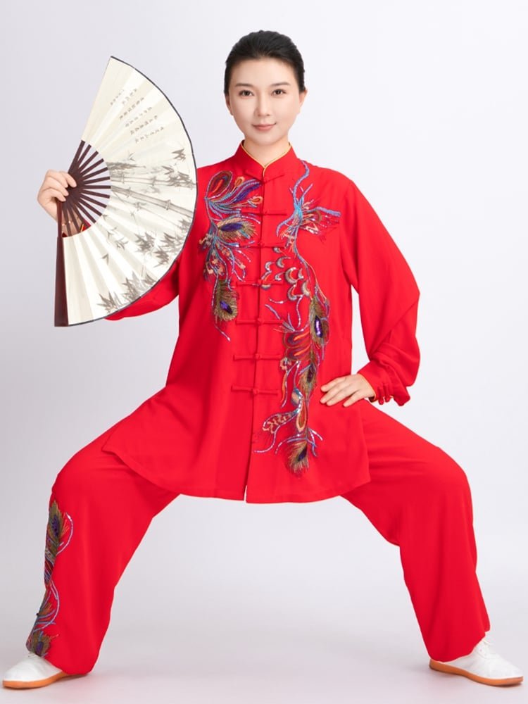 Female performer in red phoenix Tai Chi uniform holding fan