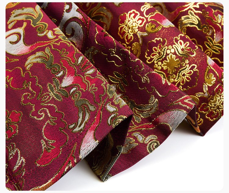 Folded fabric detail of red brocade panel