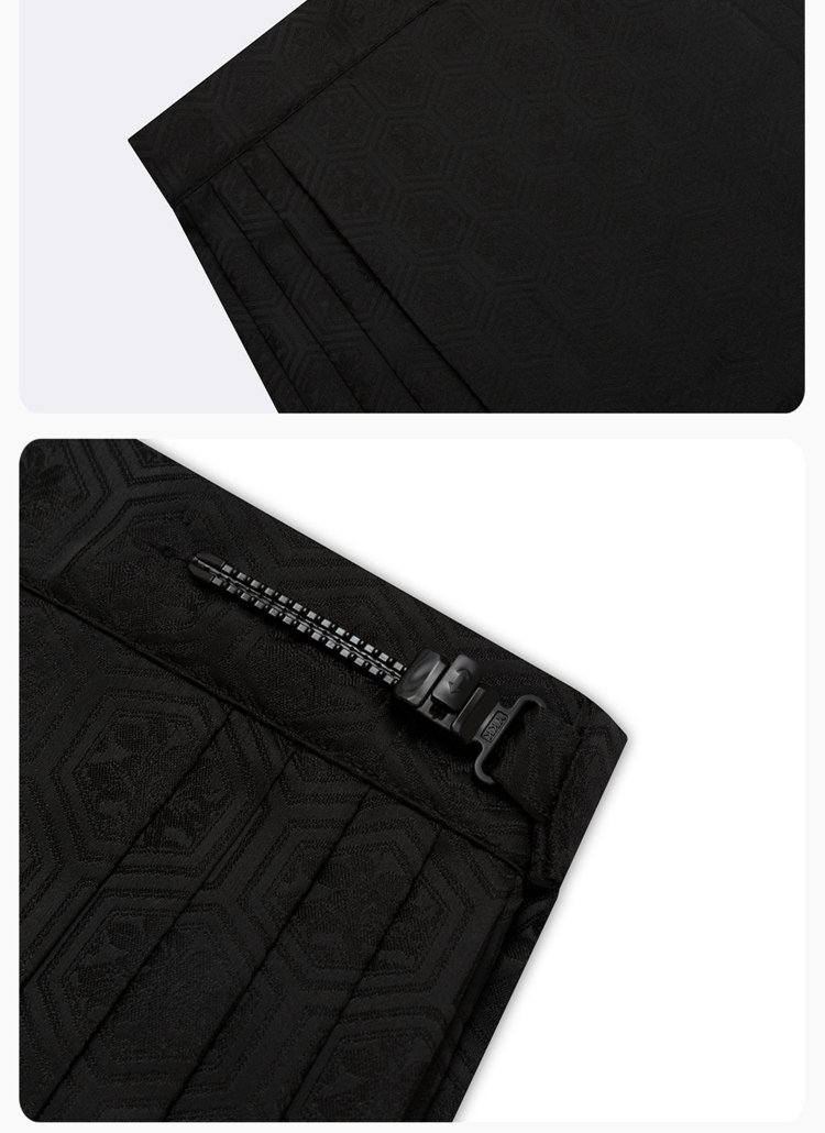 Close-up of waistband, overlapping skirt panels, and jacquard texture.