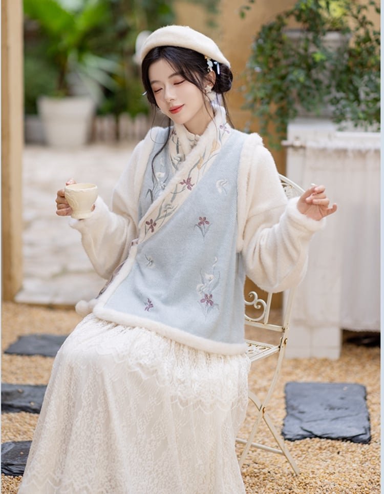 Girl wearing soft winter Hanfu-style outfit with fleece vest and lace skirt outdoors