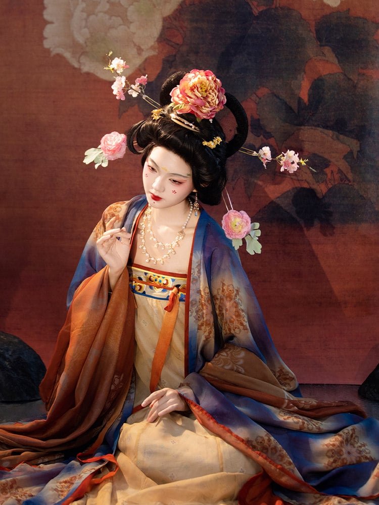 Front view of Tang dynasty mural hanfu with symmetrical wide sleeves and lotus-pattern designs inspired by Dunhuang murals.