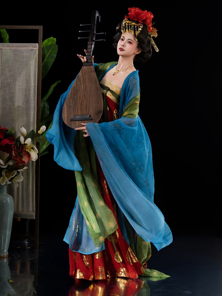 Model wearing Tang dynasty princess Hanfu dress in red and blue with gold embroidery