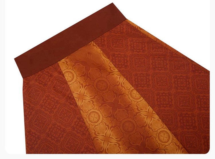 Close-up of Tang Hanfu skirt fabric showing brocade patterns inspired by Tang tri-color art.