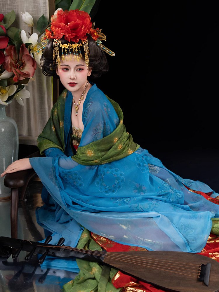 Model sitting gracefully in Tang-style Hanfu dress with gold details