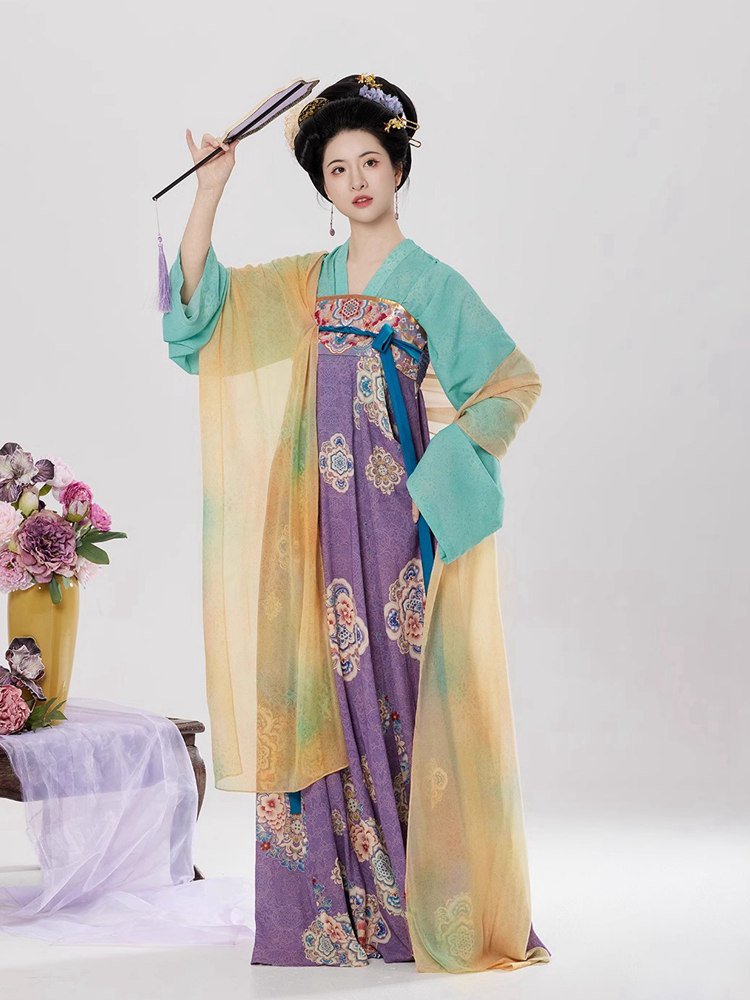 Elegant woman in Tang style chest-high Hanfu dress, holding a traditional fan and posing gracefully