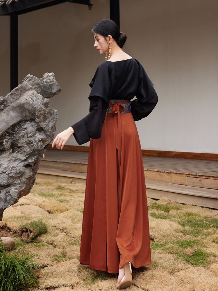 Model in side pose showing the flowing rust-orange hanfu skirt