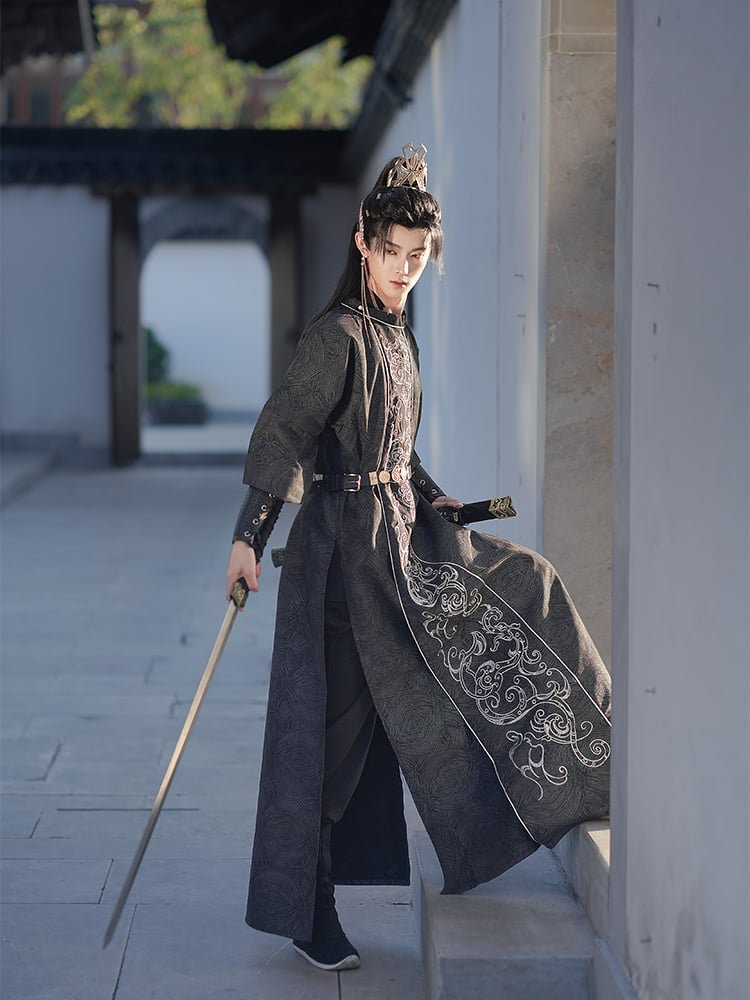 Model wearing Tang-style black Hanfu robe for men, elegant oriental outfit for performance and photography.